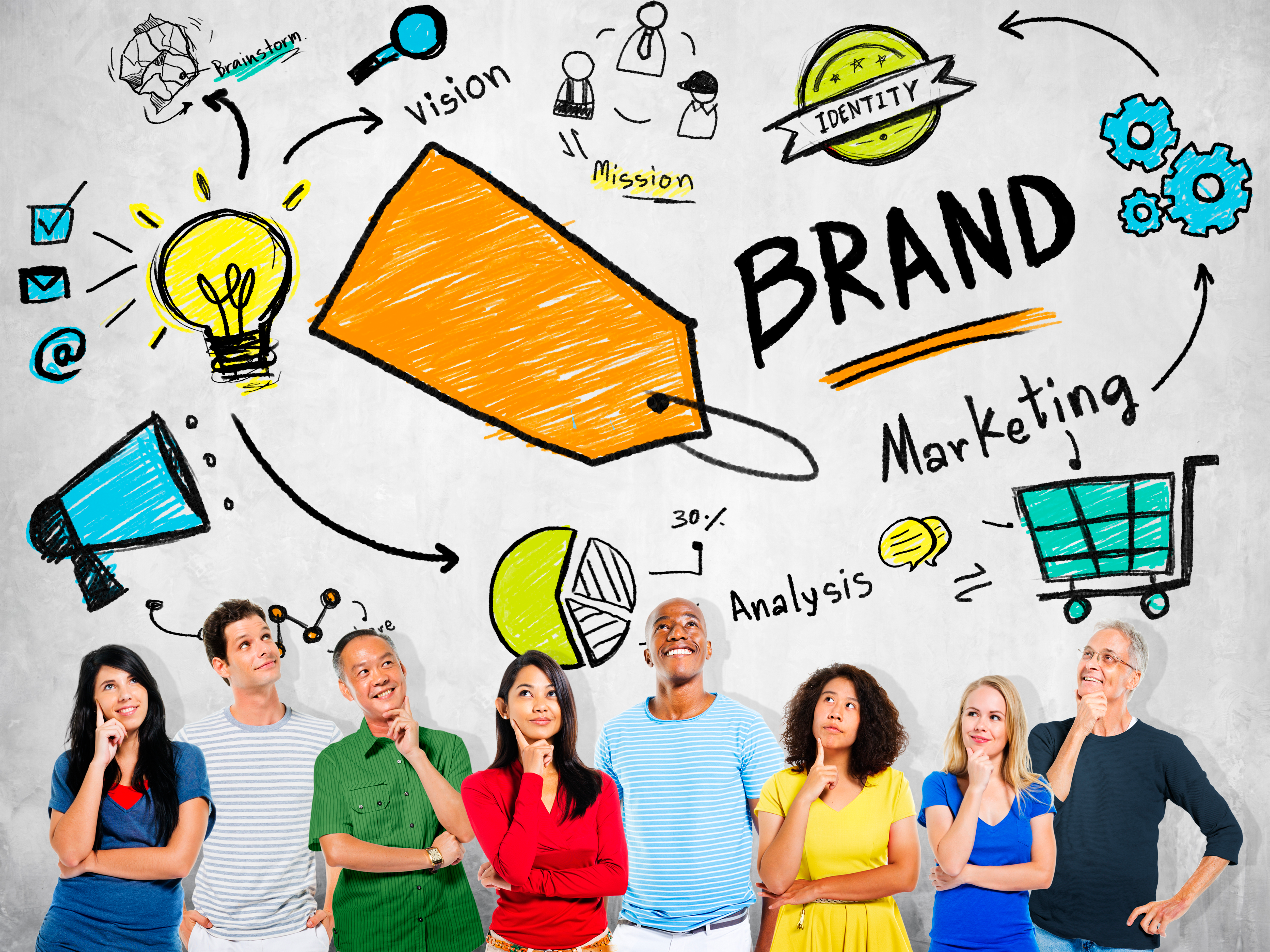 Group of diverse people standing together with creative branding service concepts drawn on the wall.